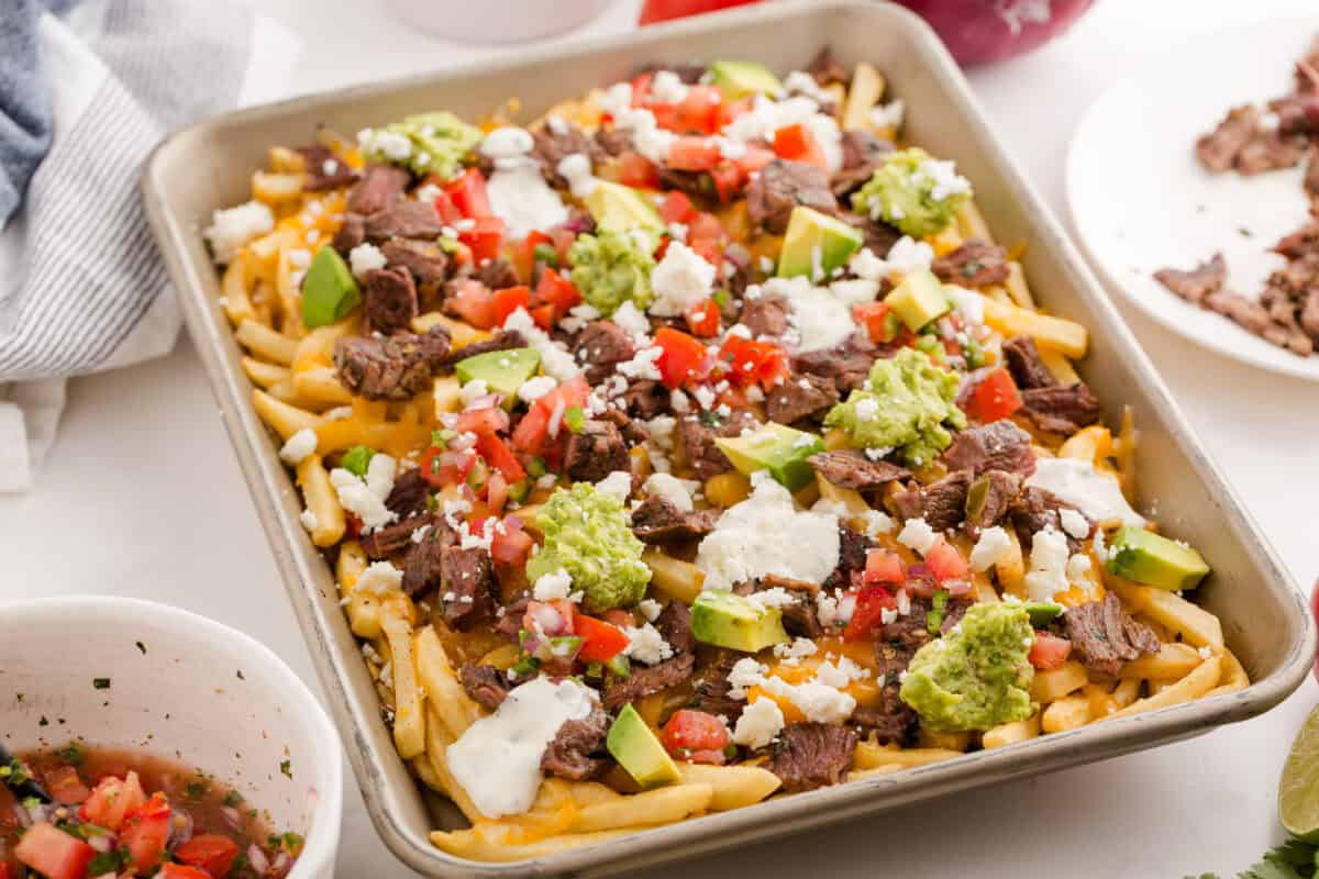 carne asada fries on a sheet pan