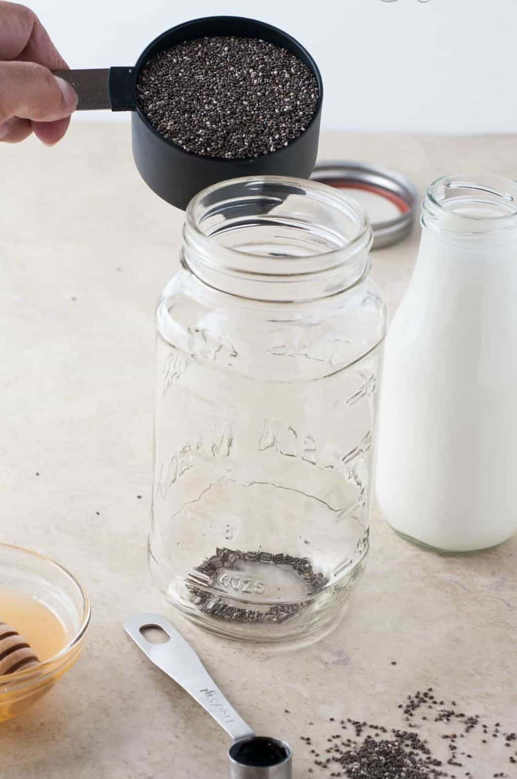 adding chia seeds to a mason jar