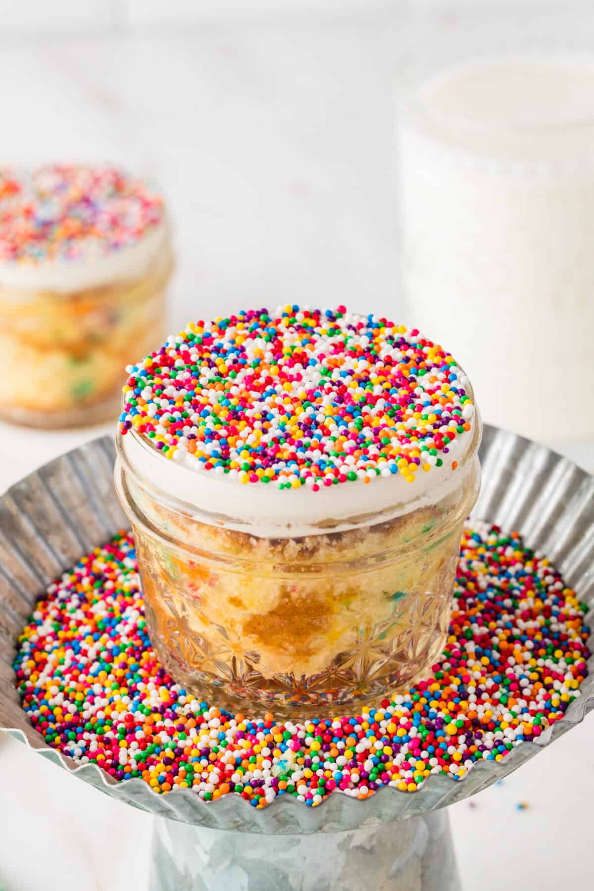 dot cake in a jar in a tray of sprinkles
