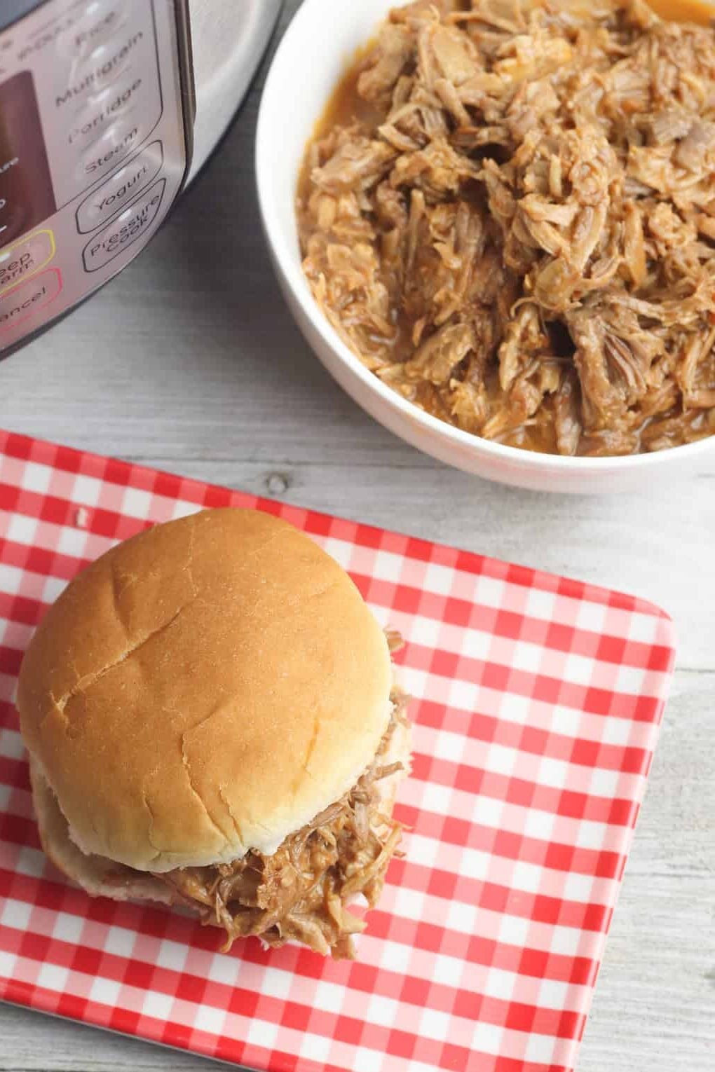 pulled pork in a bowl and on a bun