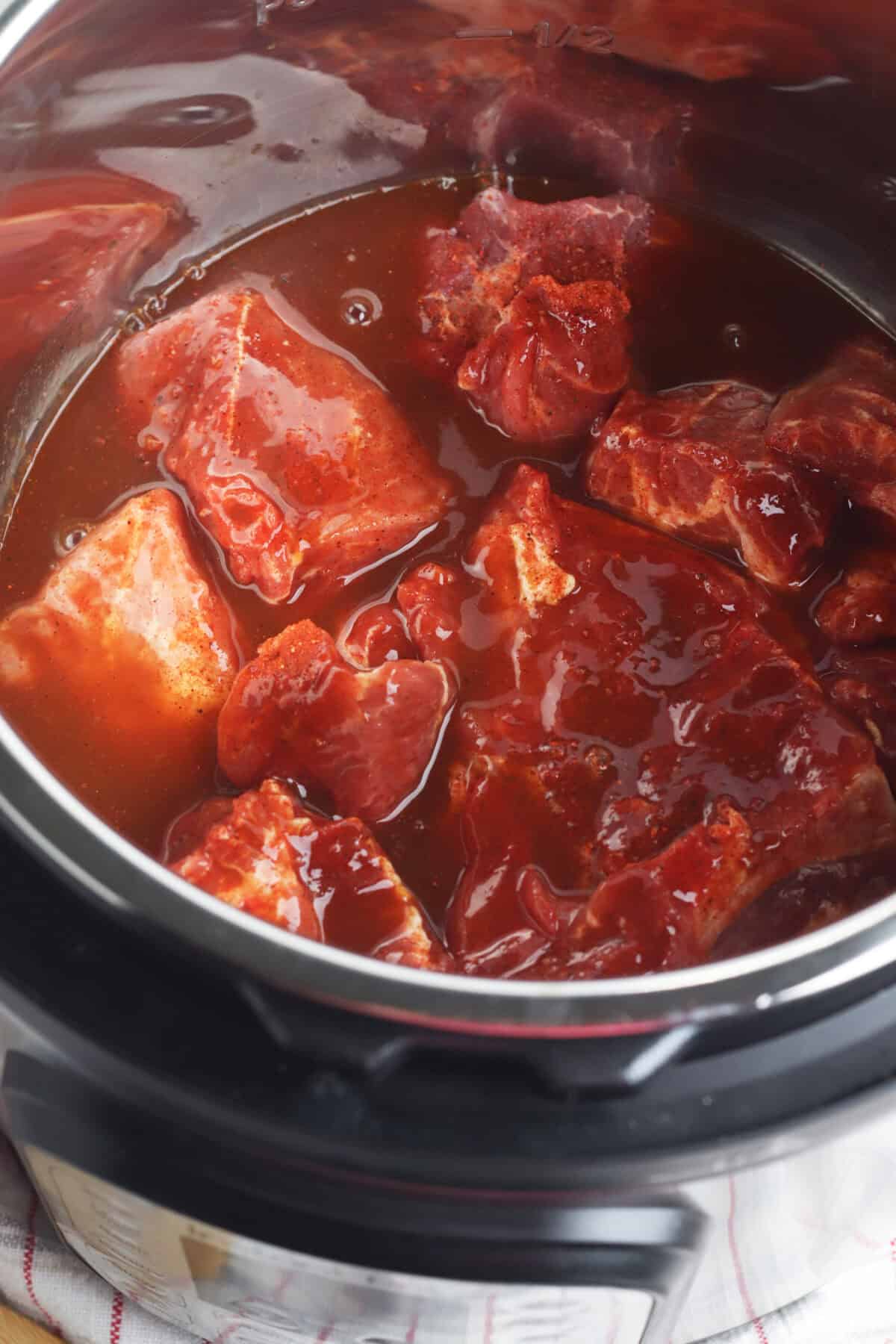 pork in instant pot with sauce over it