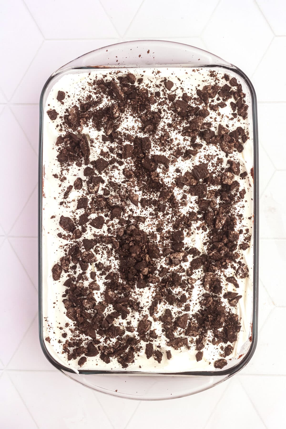 whipped cream and oreos on top of cake