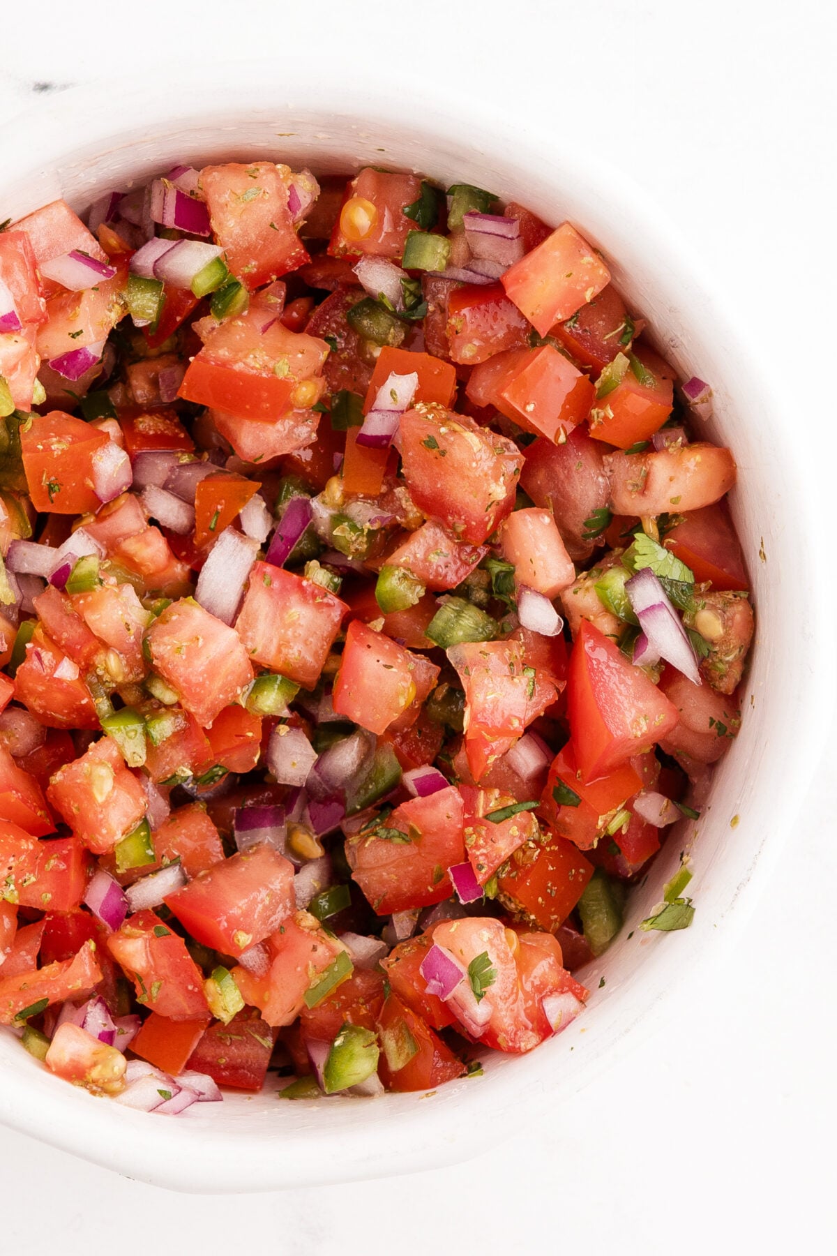 fresh pico de gallo in white bowl
