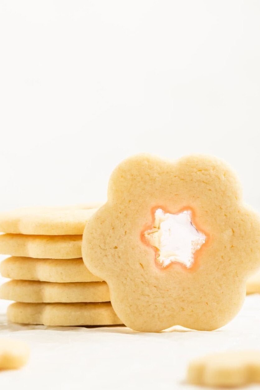 stained glass cookie propped up next to a stack of cookies