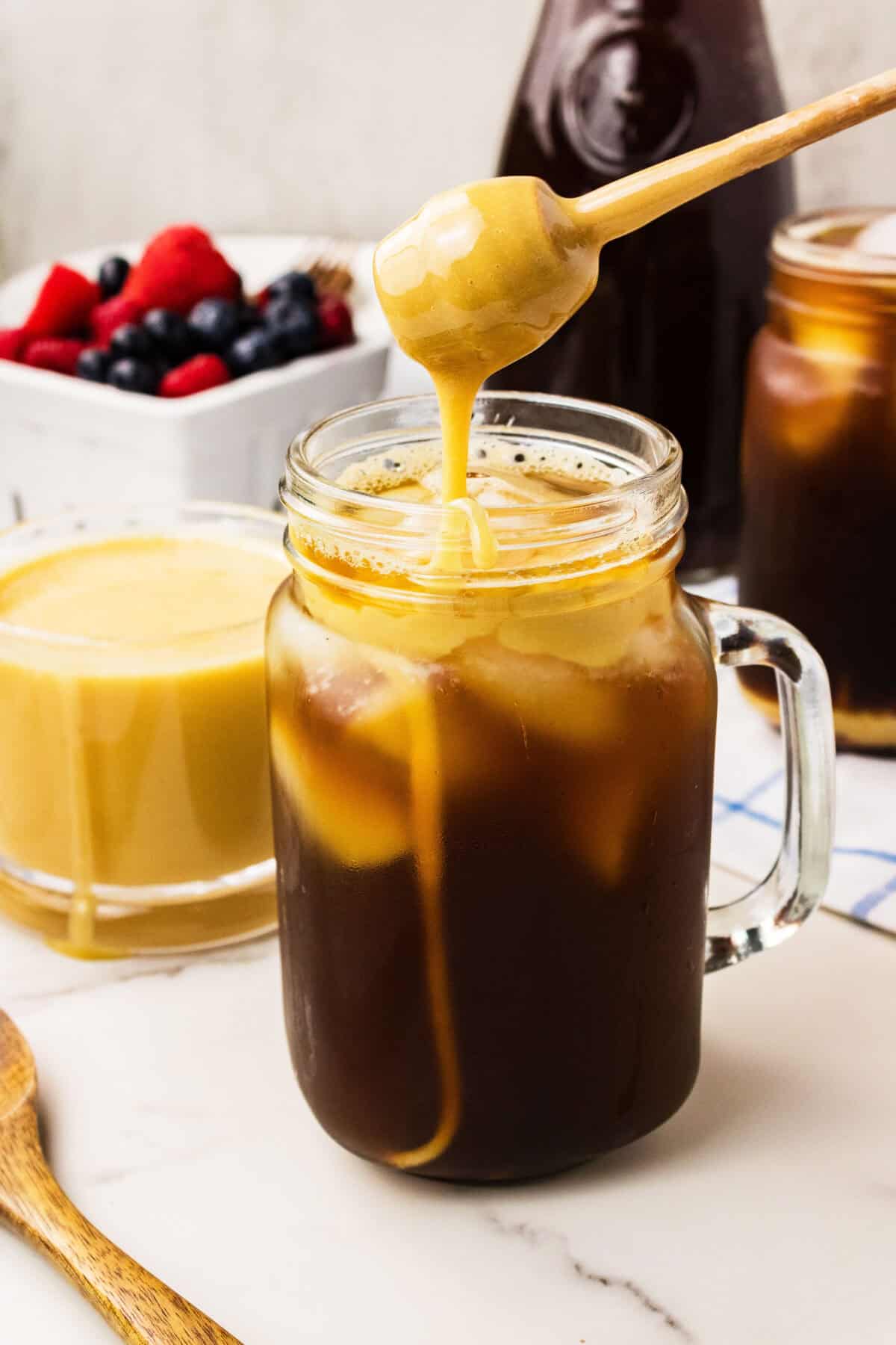 drizzling whipped honey into coffee