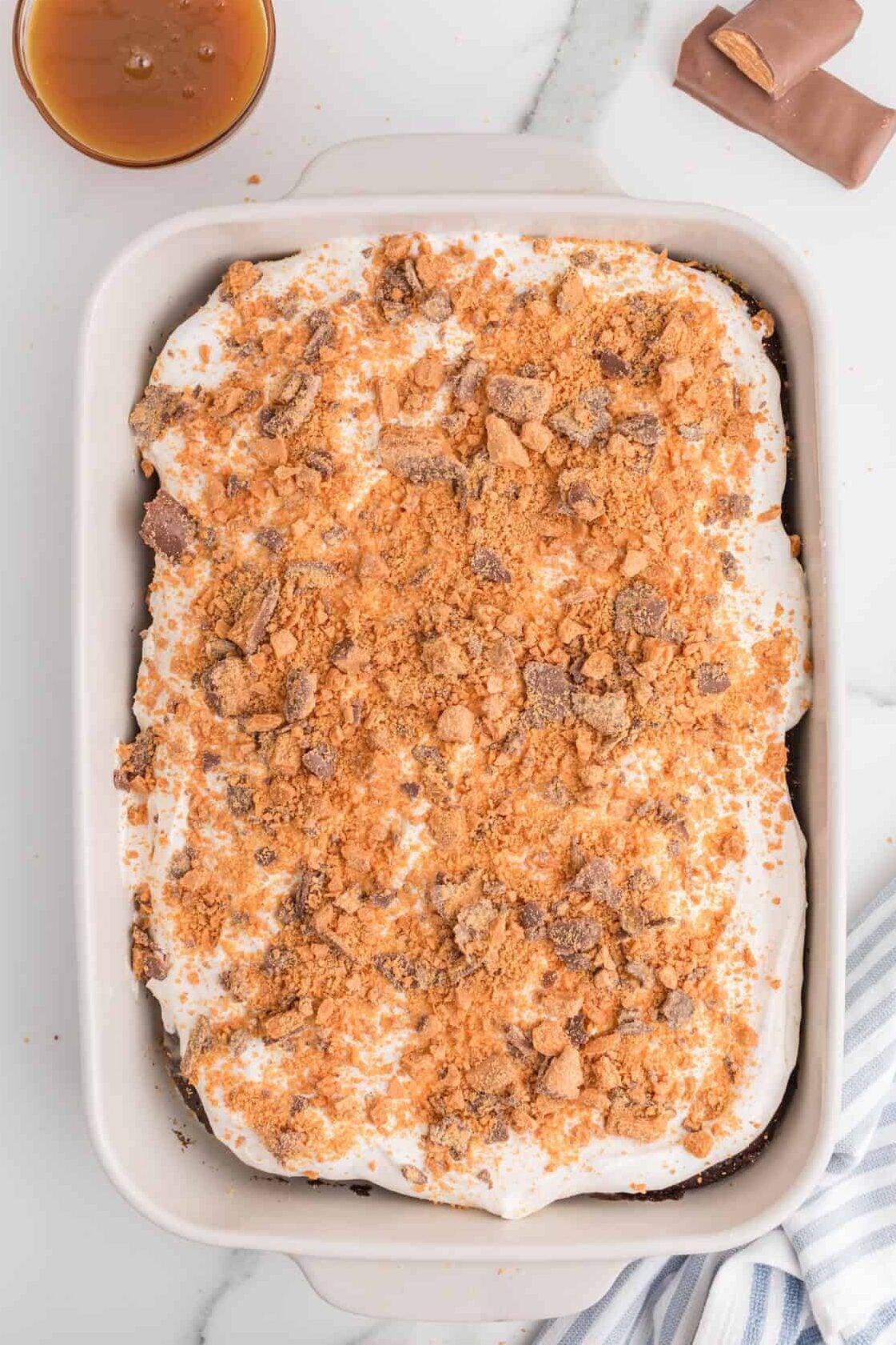 chopped butterfingers over the top of a cake