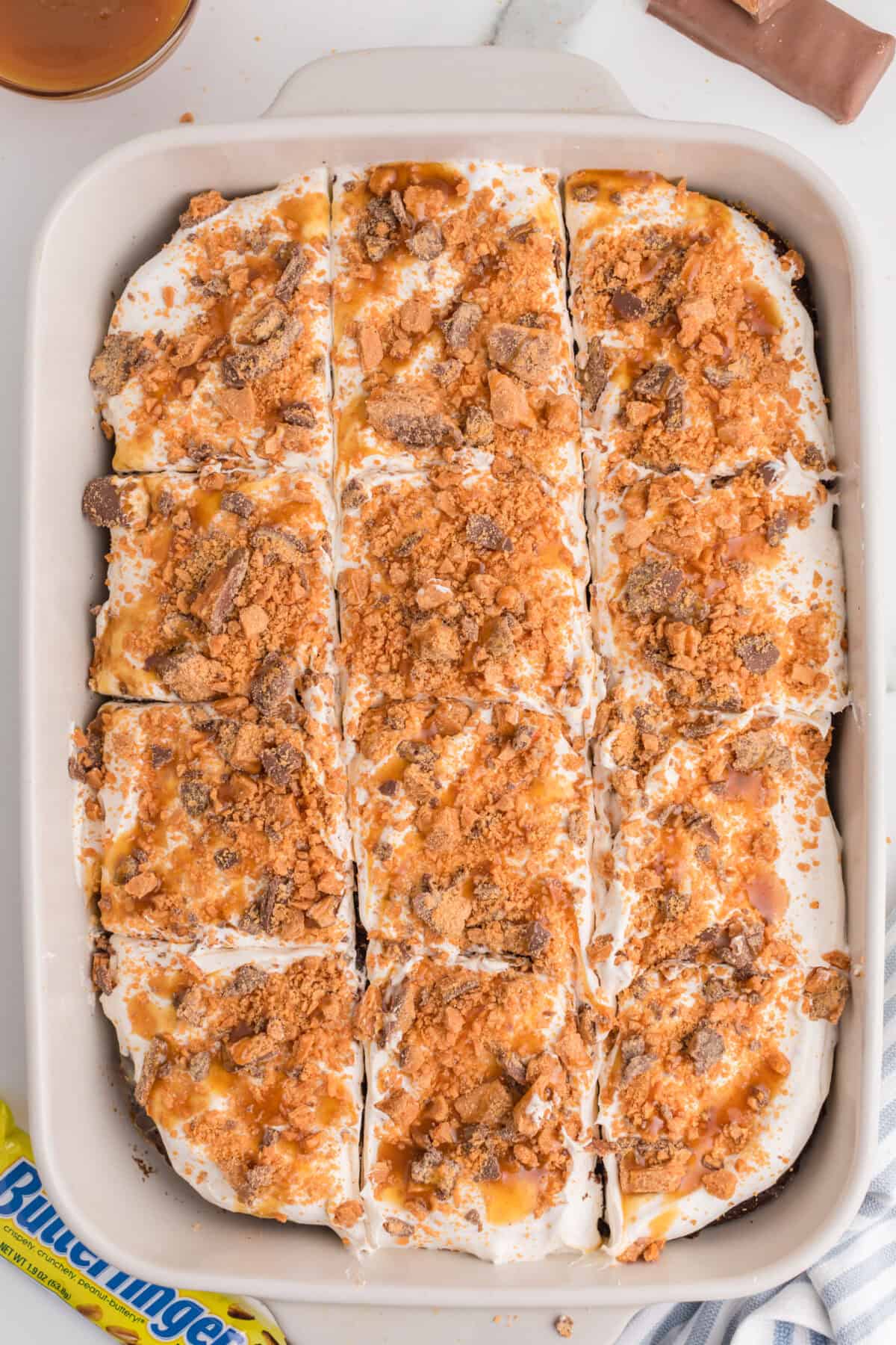 butterfinger poke cake cut into 12 squares