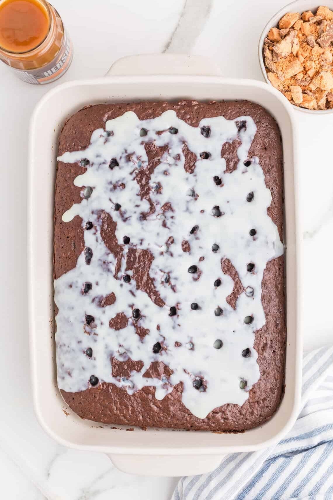 condensed milk pored over chocolate cake