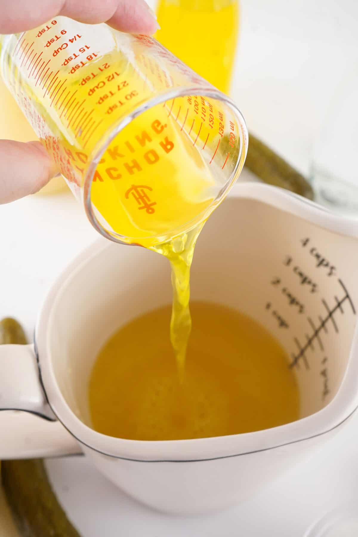 pouring pickle juice into mixture