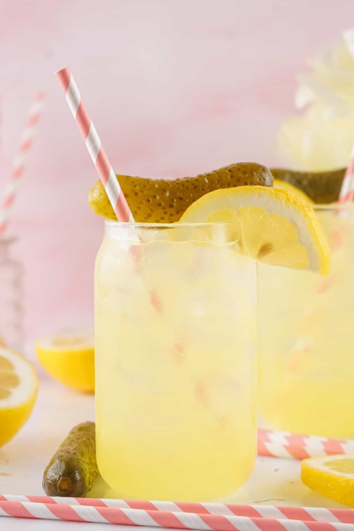 dill pickle lemonade in a mason jar with pink straws