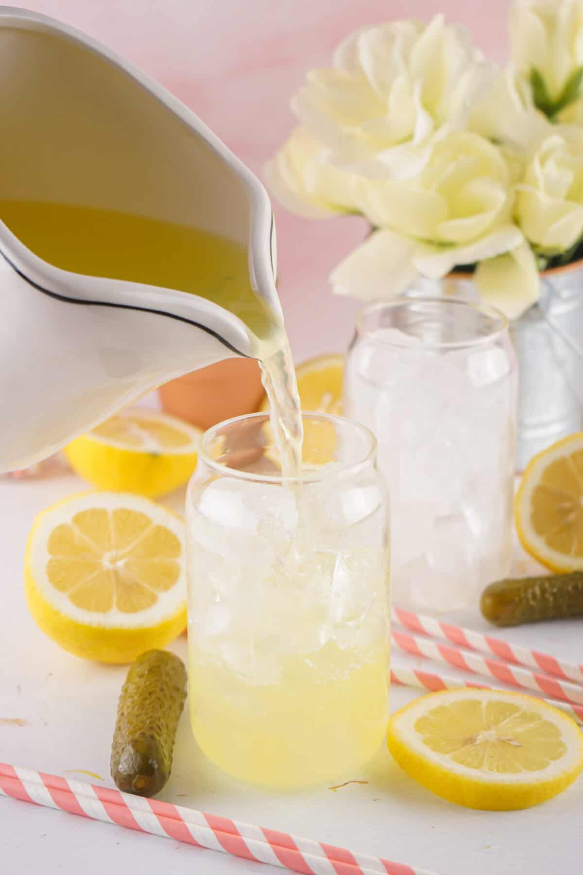 pouring dill pickle lemonade over ice