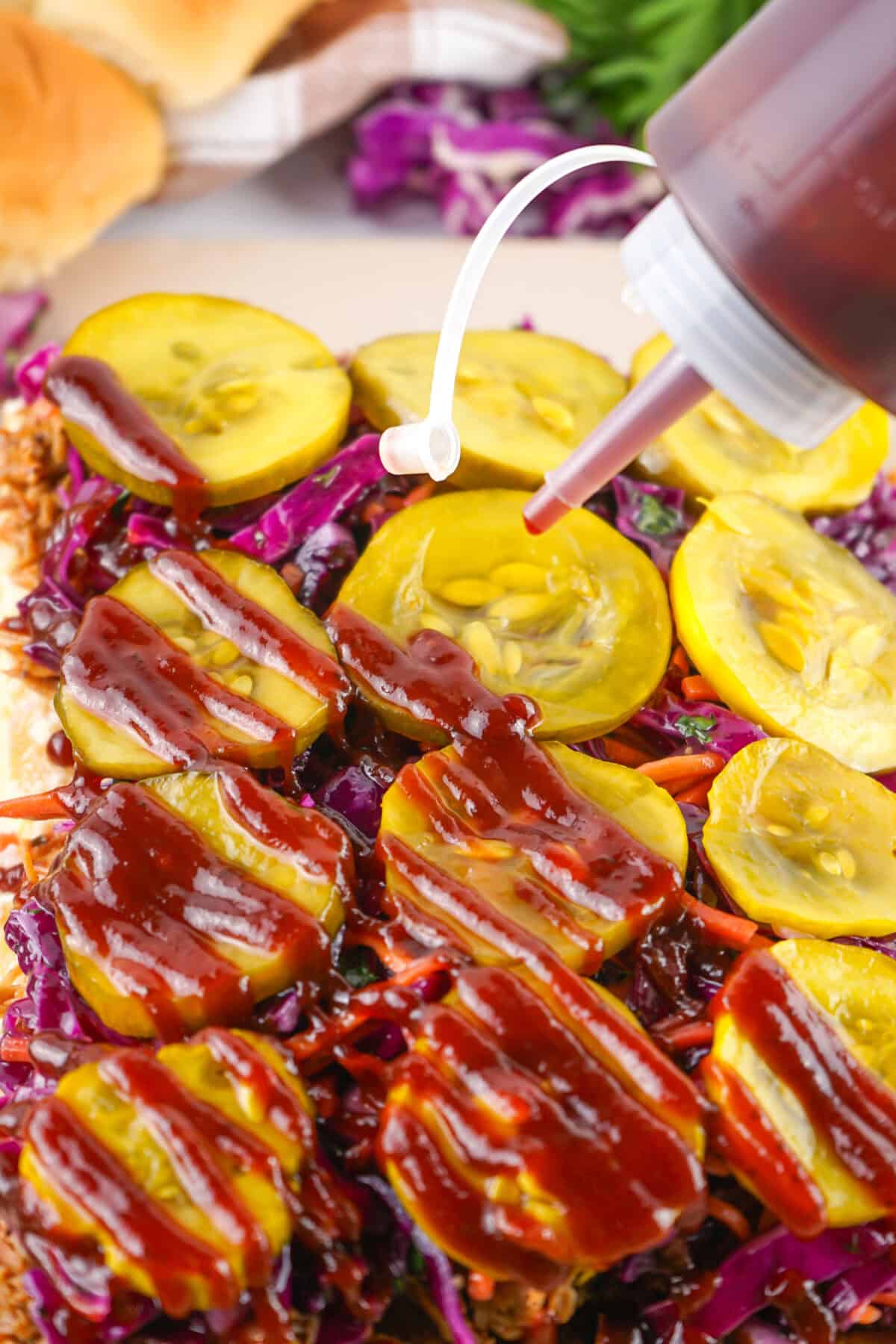 bbq sauce drizzled over pulled pork sandwiches