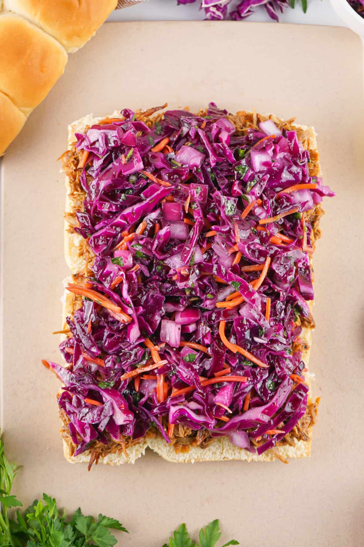 slaw spread over bbq pork on hawaiian rolls