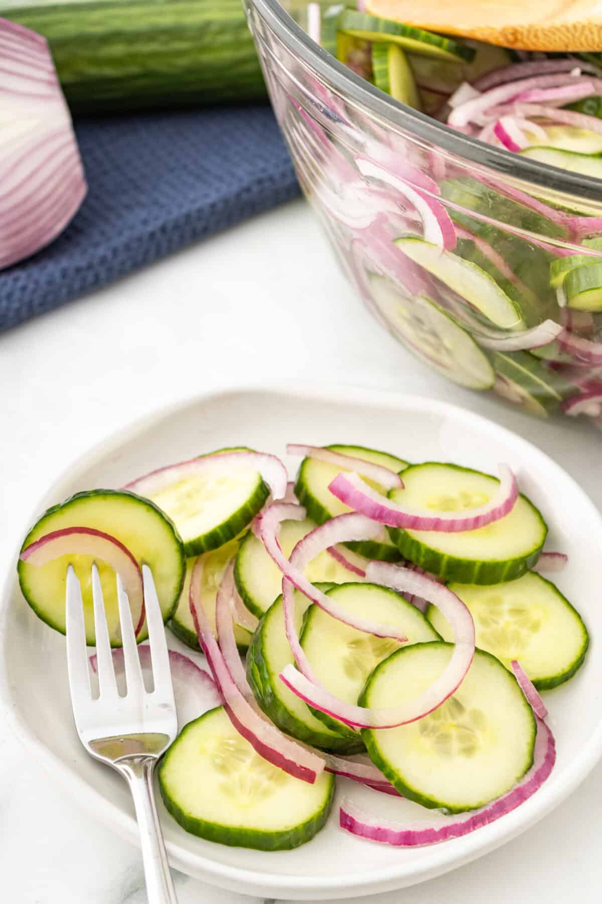 cucumbers and onions on a plate with a fork