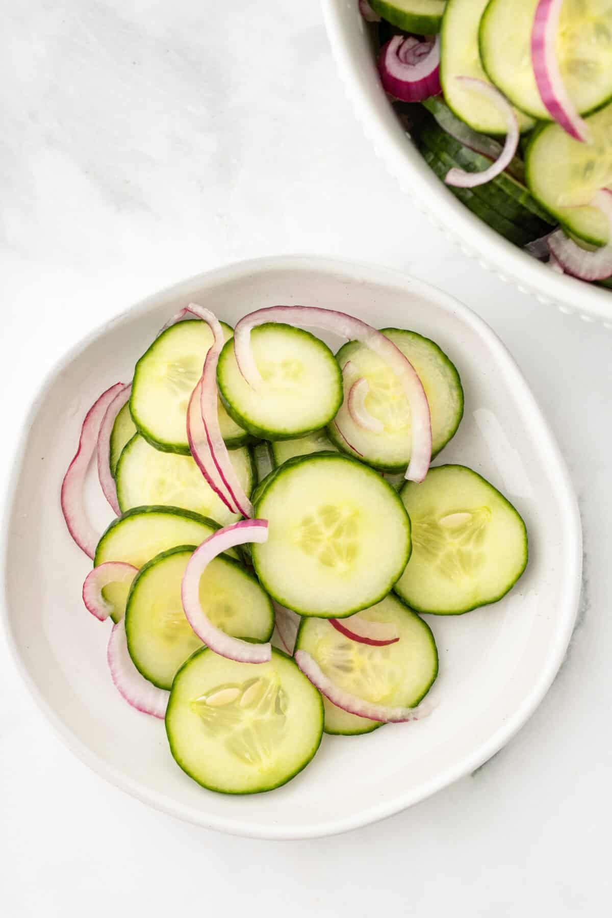 cucumbers and onions on a white plate