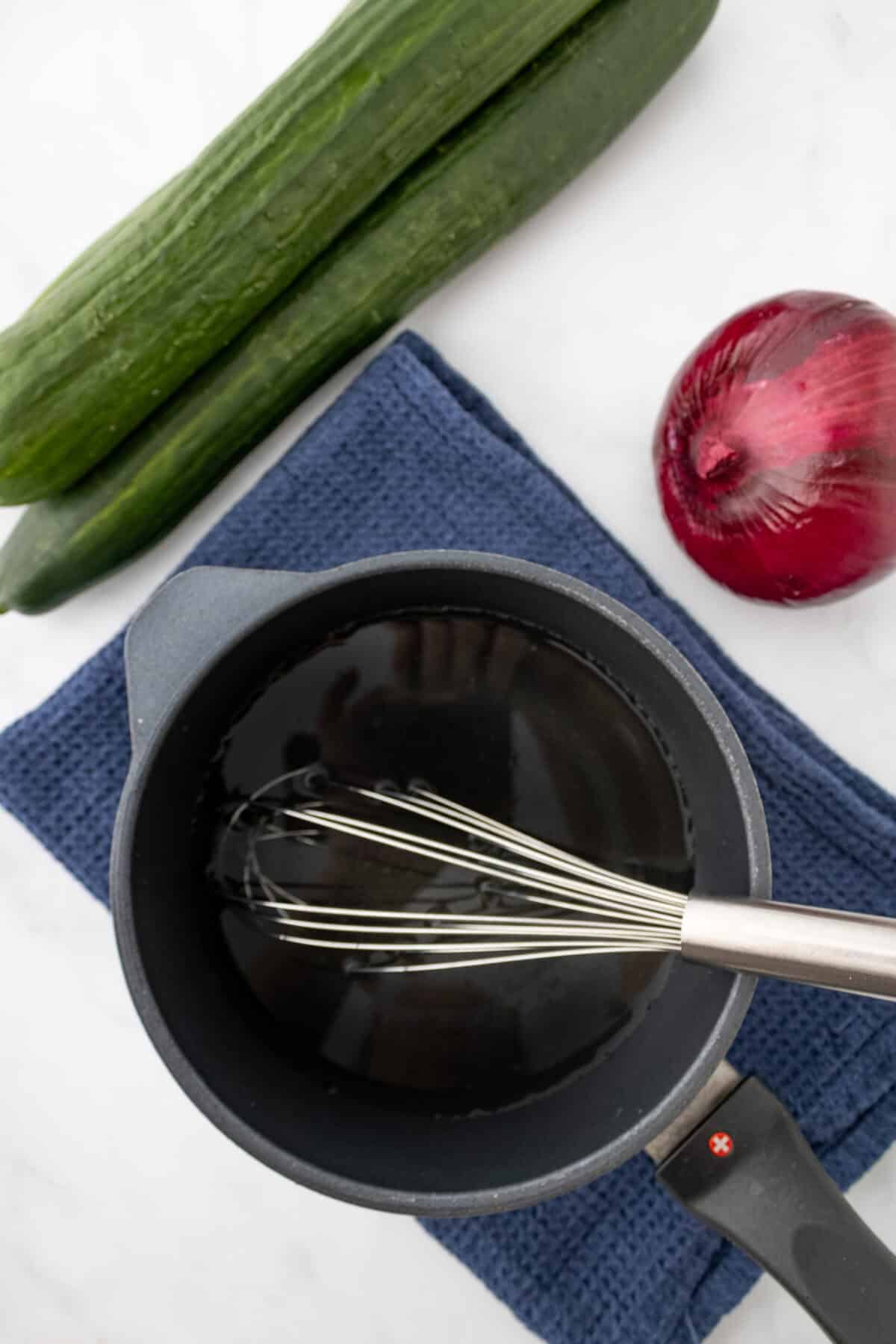 cucumbers and onions dressing in a pot
