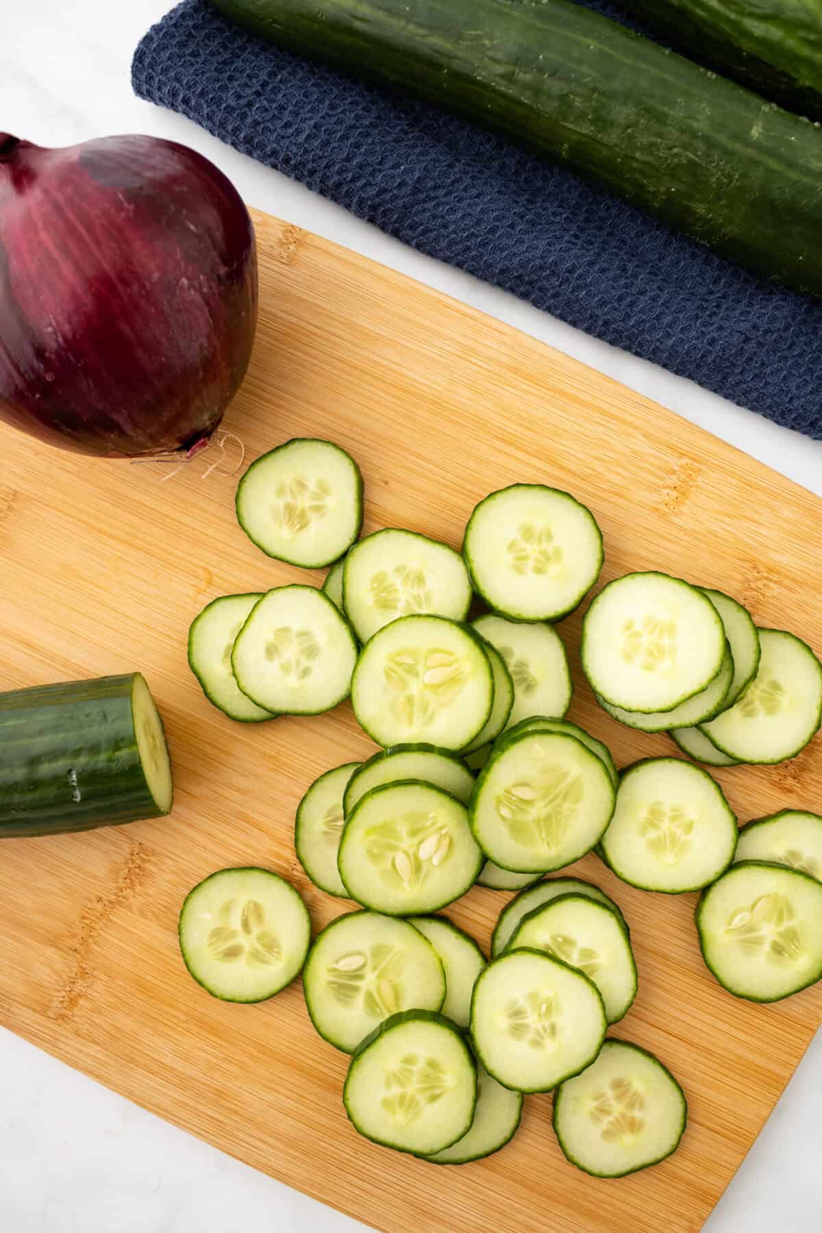 sliced cucumbers on a cutting board