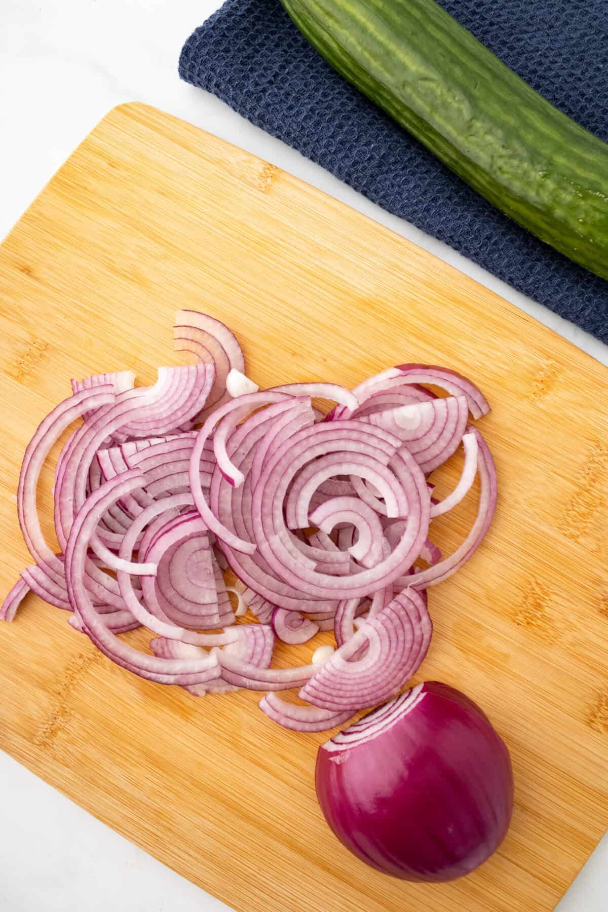 sliced red onions on a cutting board