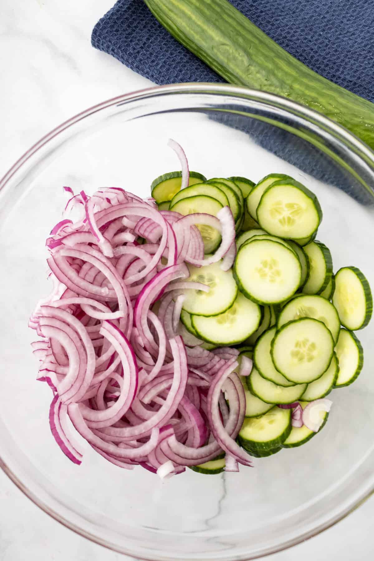 onions and cucumbers in a clear bowl
