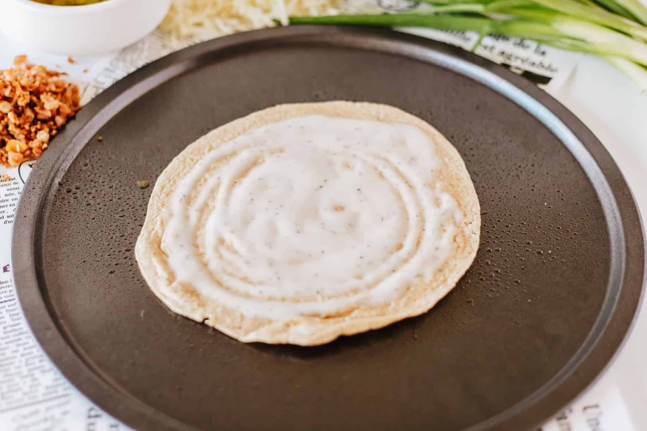 ranch dressing spread on tortilla