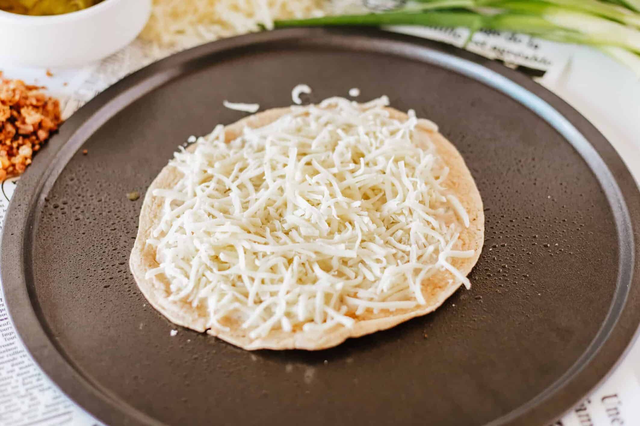 mozzarella spread over ranch dressing on a tortilla