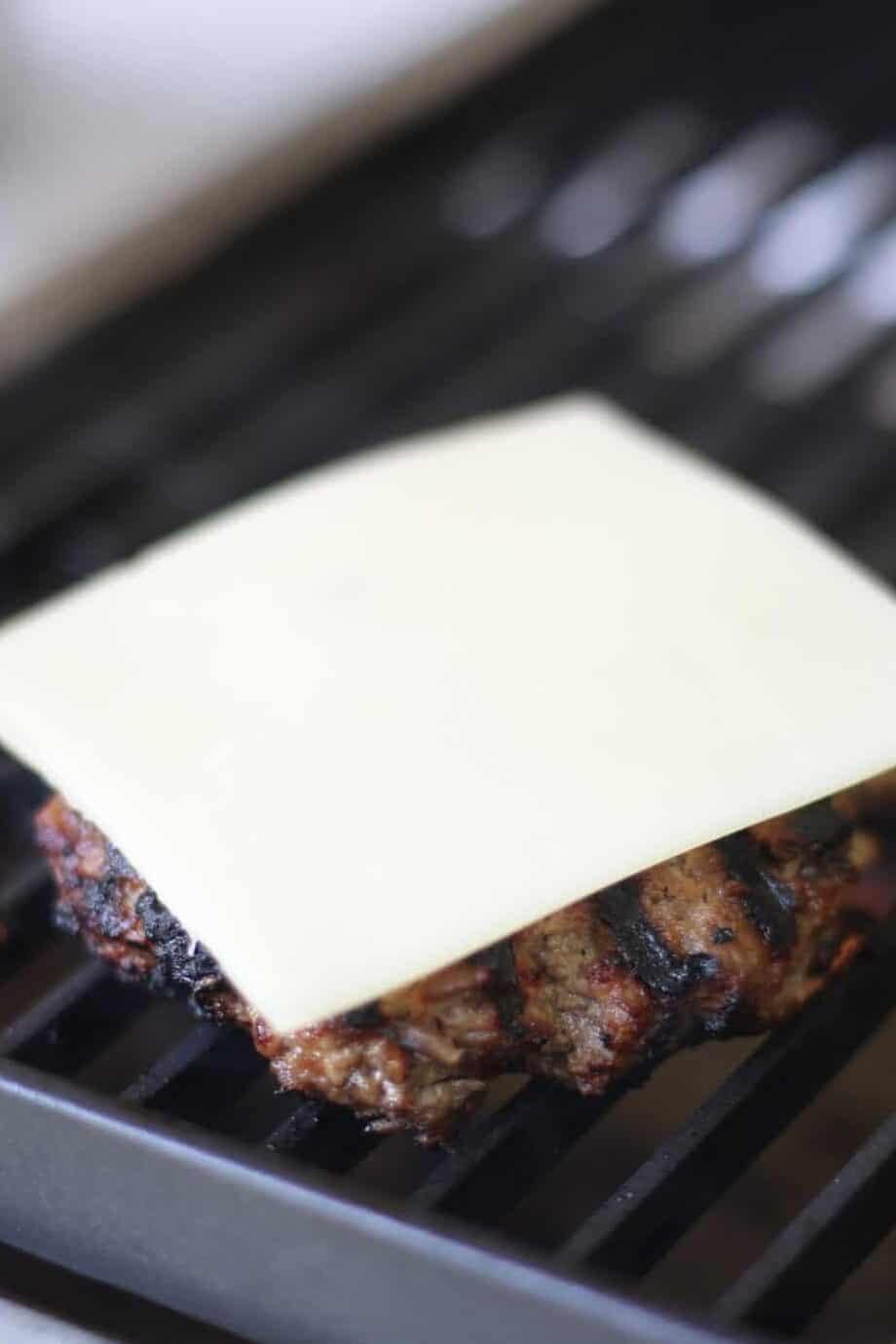 grilled burger with cheese on it