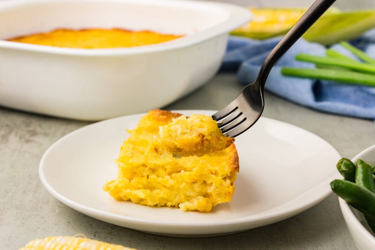 square of jiffy corn casserole with a bite on a fork