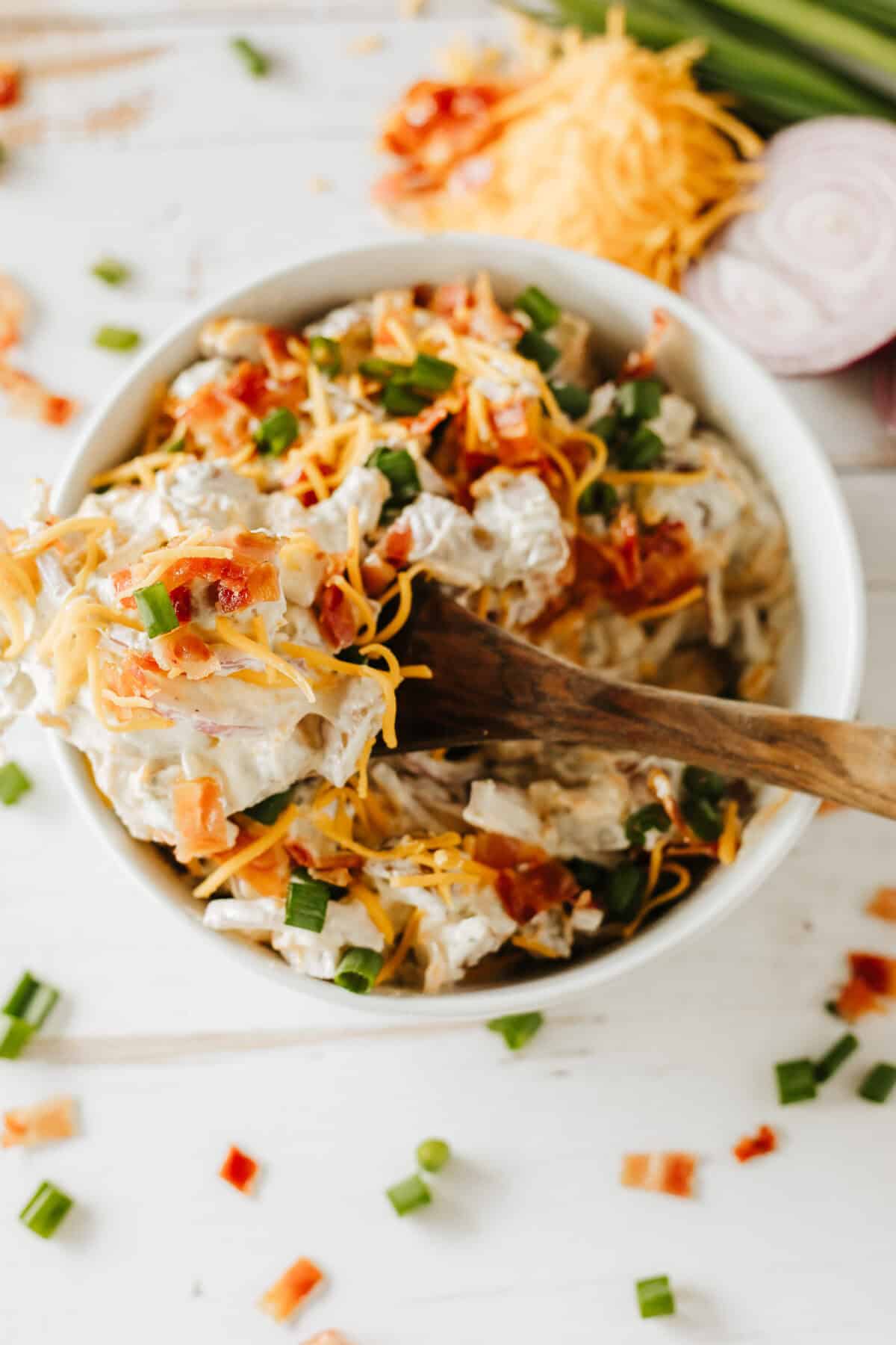 bowl of baked potato salad with a fork in it