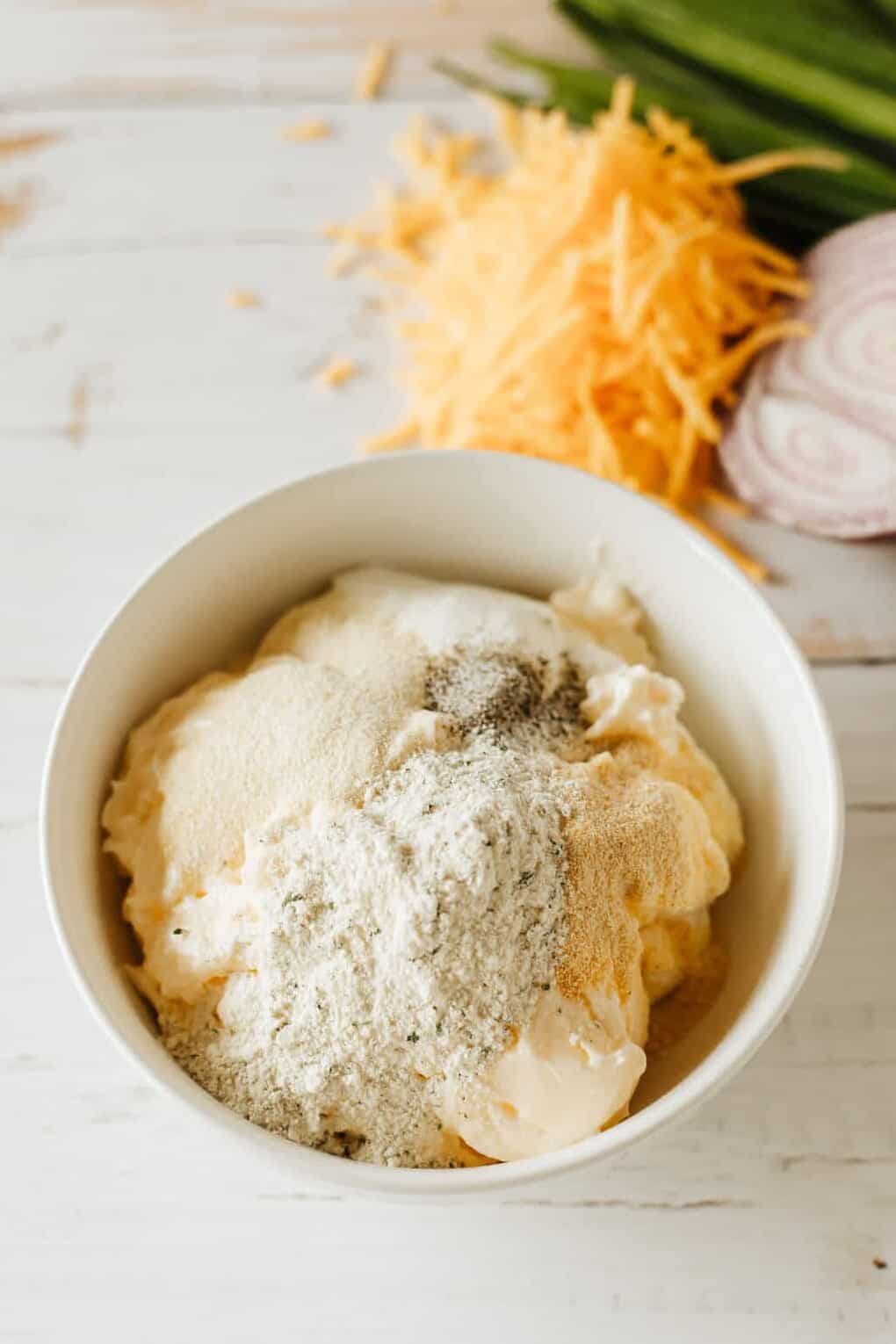 mayo and sour cream in a bowl with seasoning on top