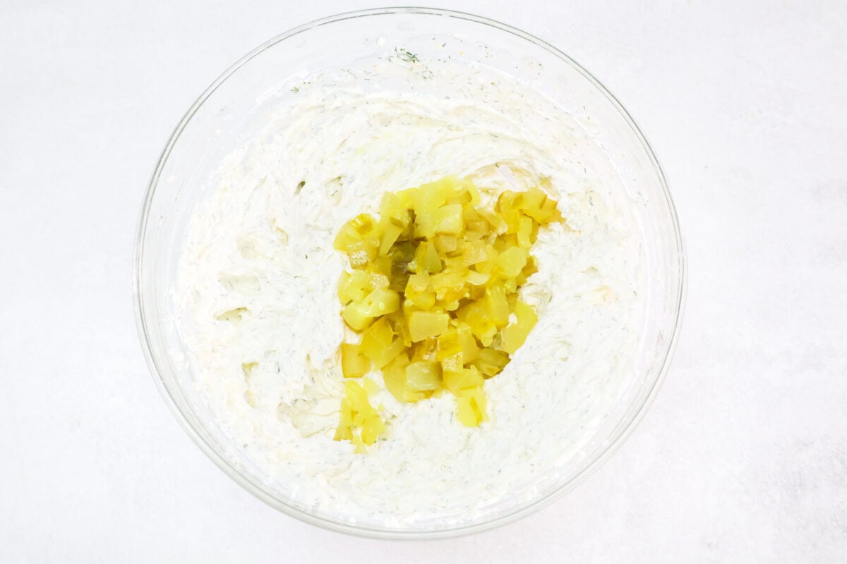 chopped dill pickles added to bowl