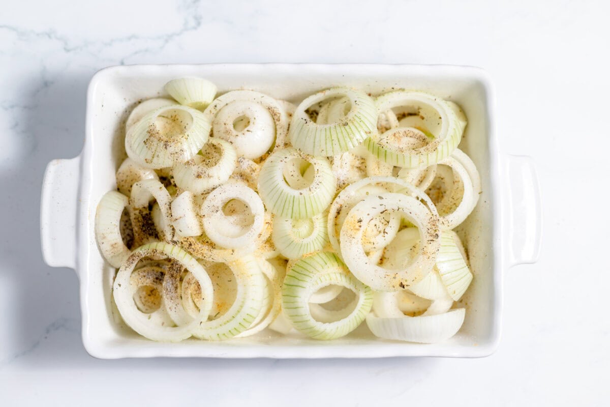 sliced onions in a baking dish