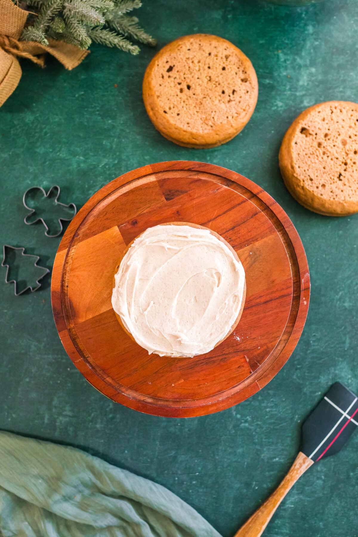 single layer of spice cake on a cake stand with frosting on top