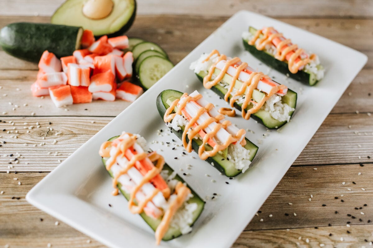 cucumber sushi boats on a white platter