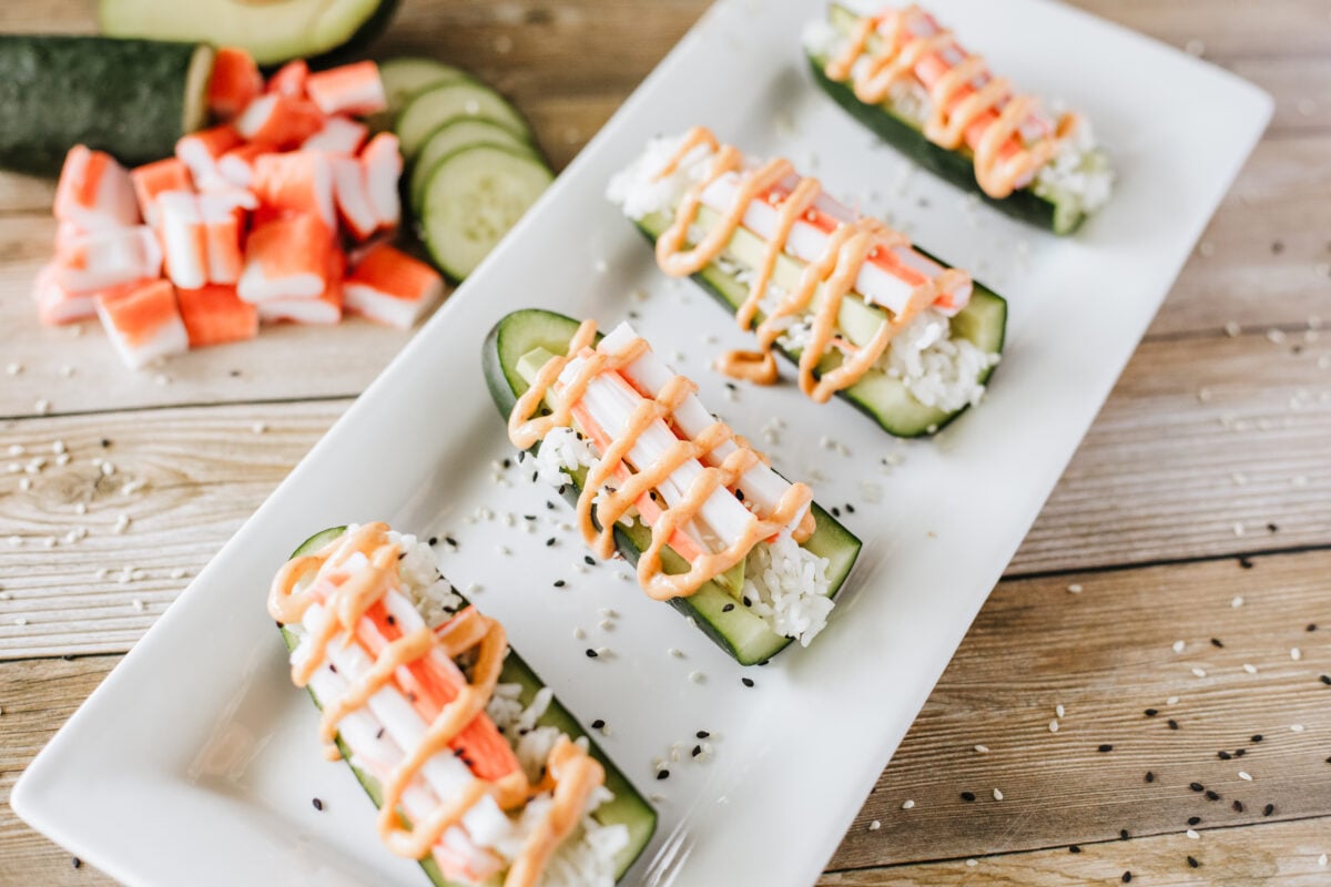 cucumber sushi boats on a white platter
