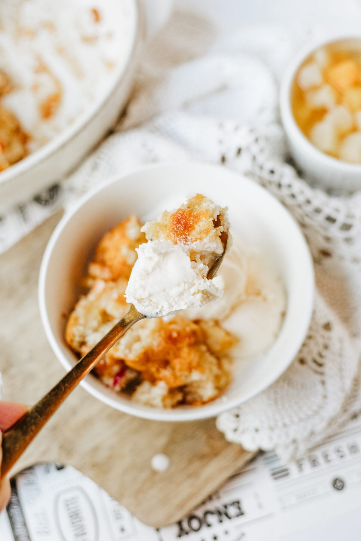 fruit cocktail cake on a fork with ice cream