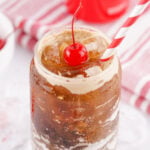 fluffy coke with a cherry and a straw