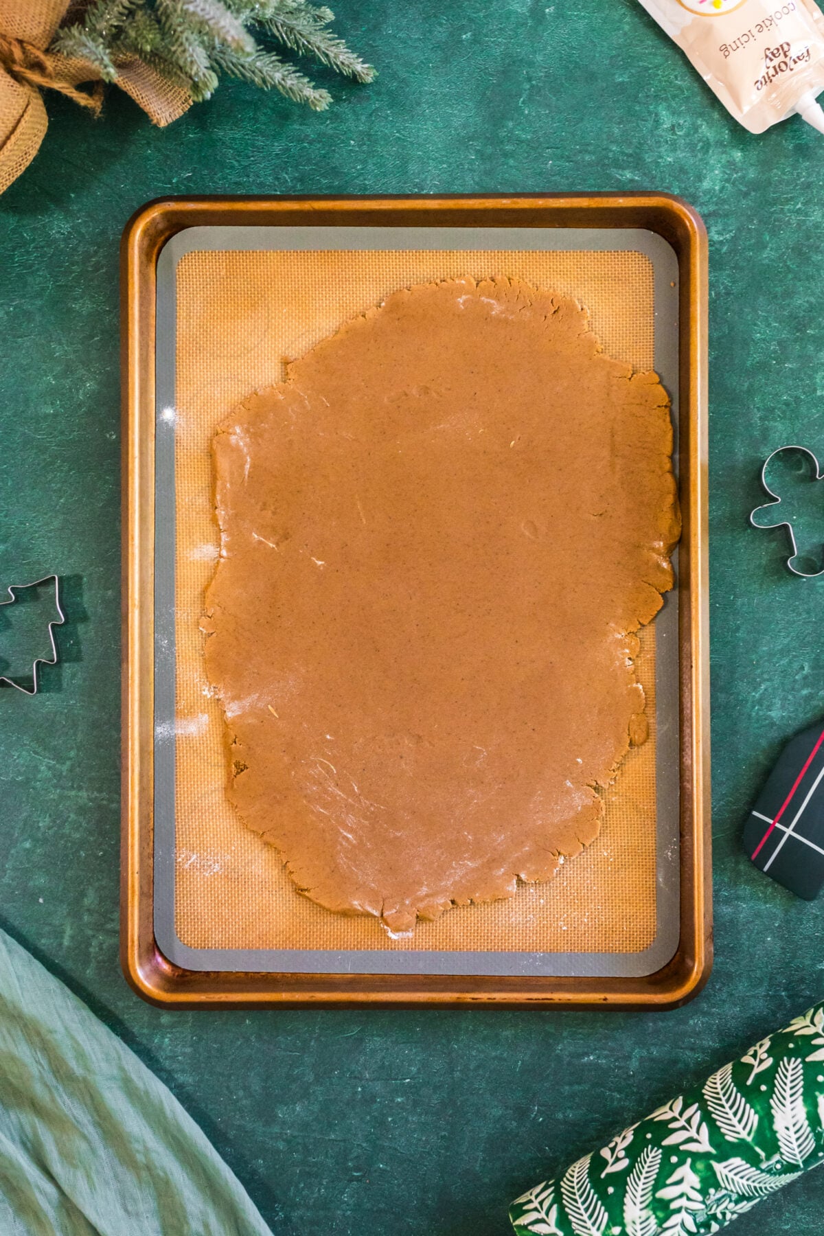 gingerbread cookie dough rolled out on parchment
