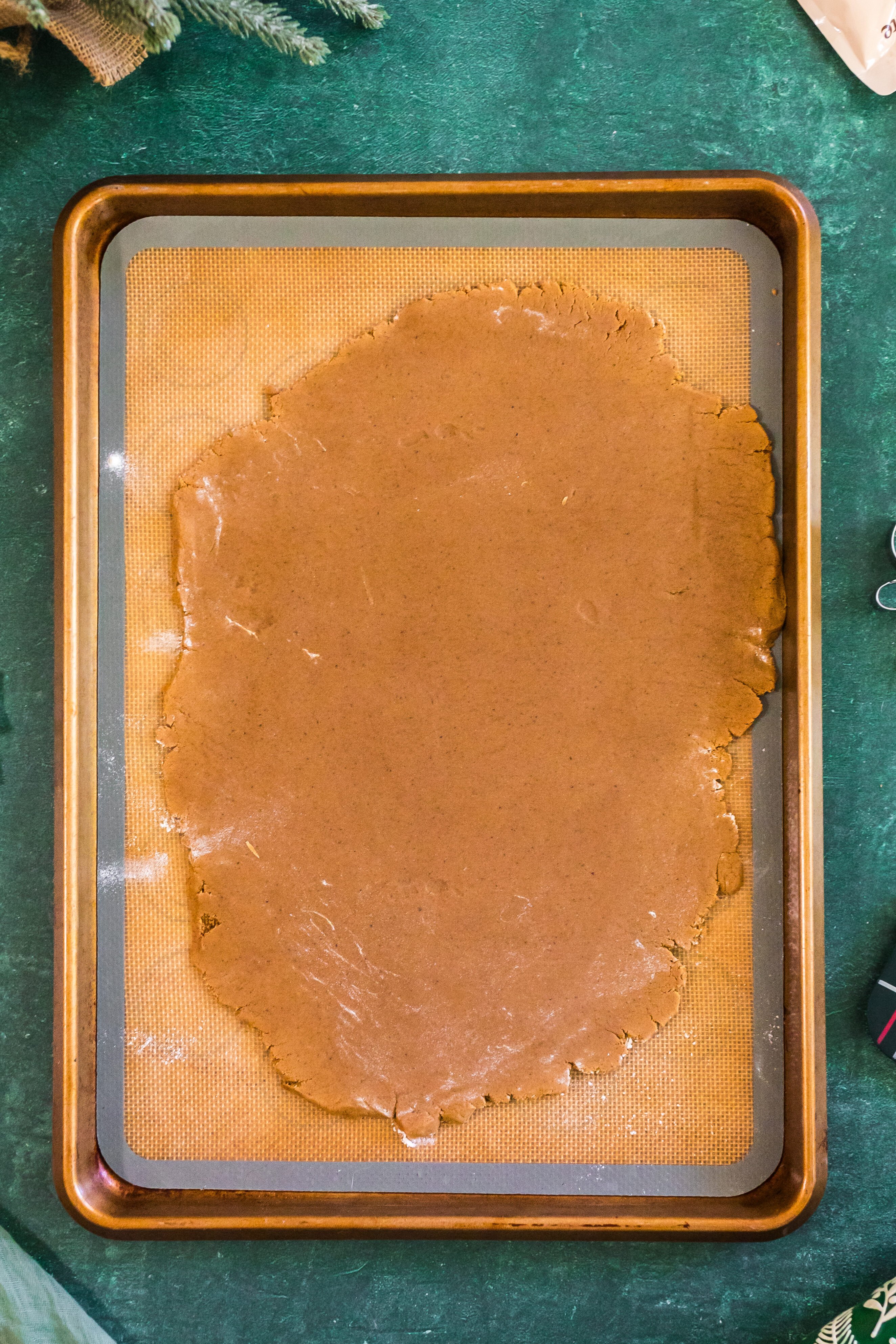gingerbread cookie dough rolled out on parchment