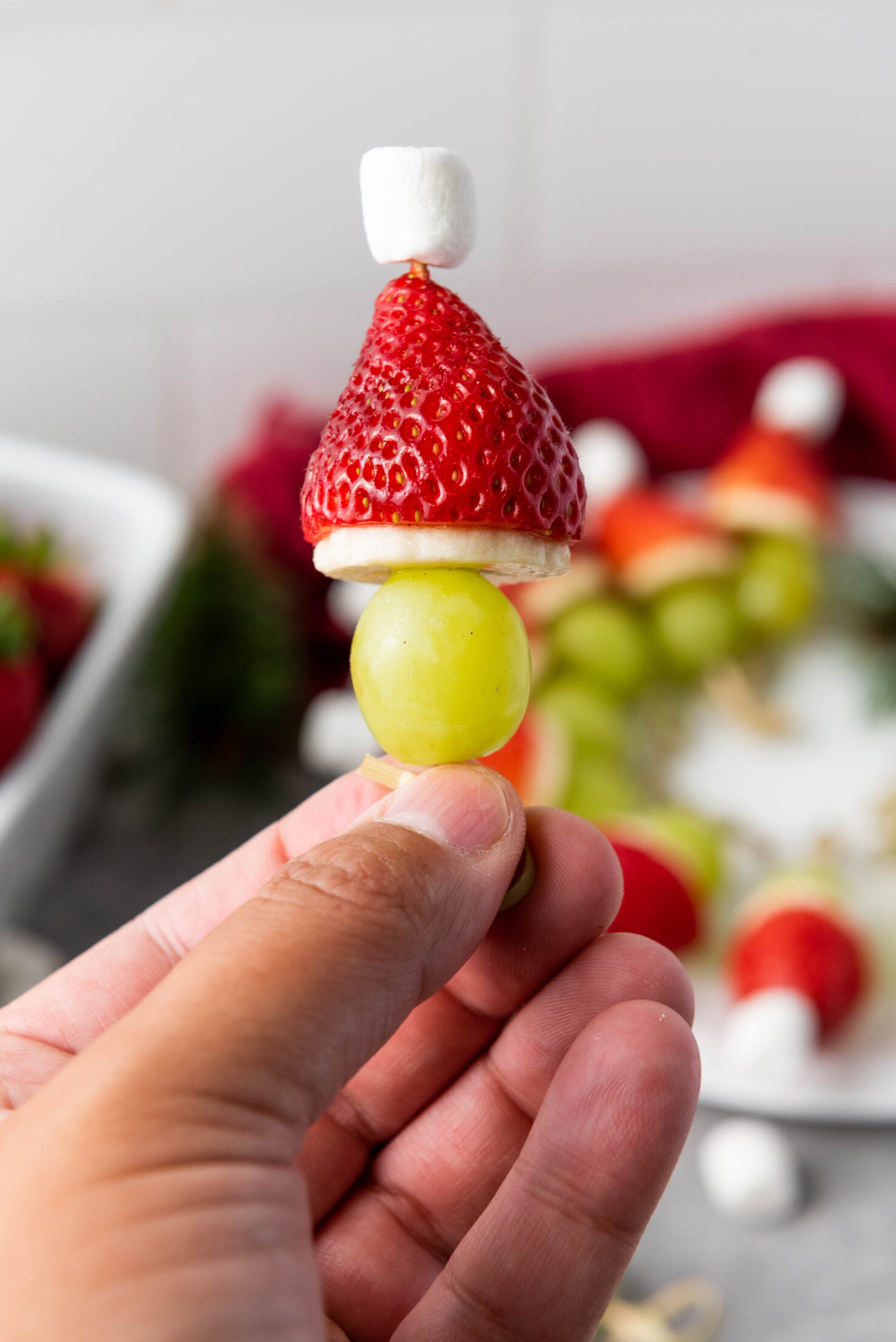 grinch fruit kabob being held by hand