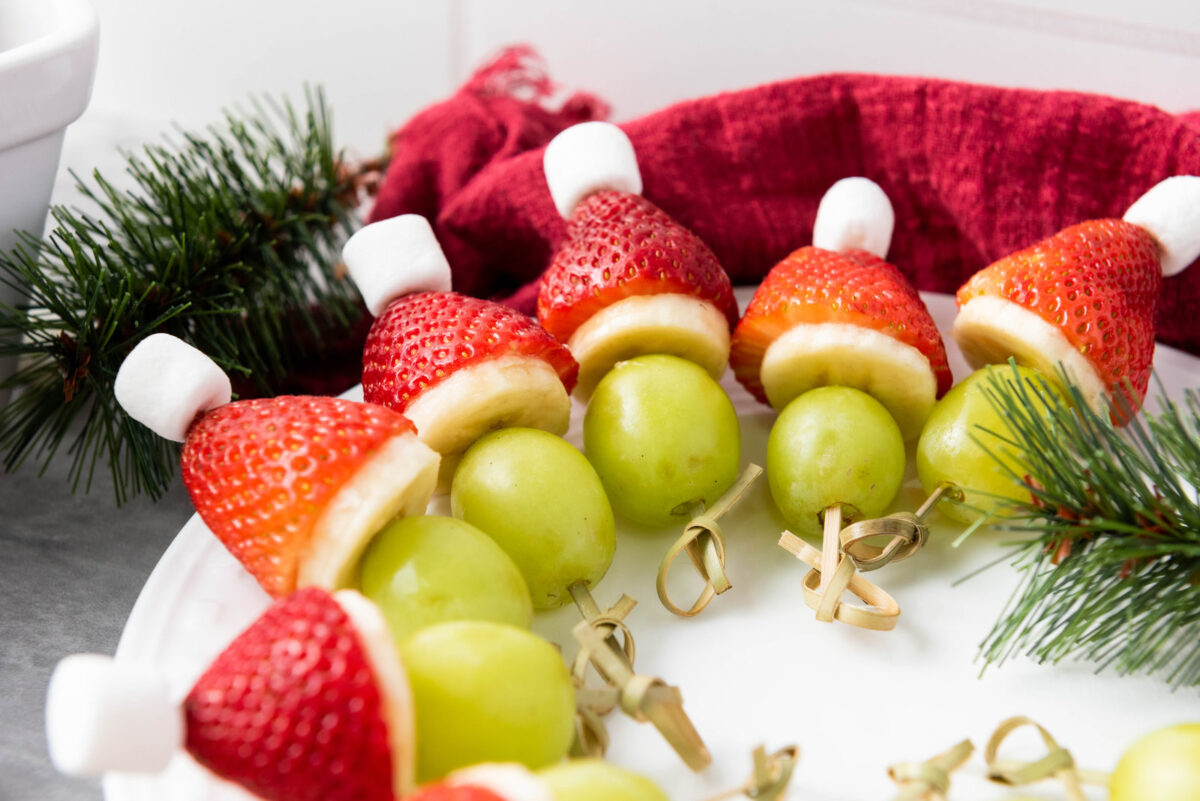 grinch fruit kabobs on a platter
