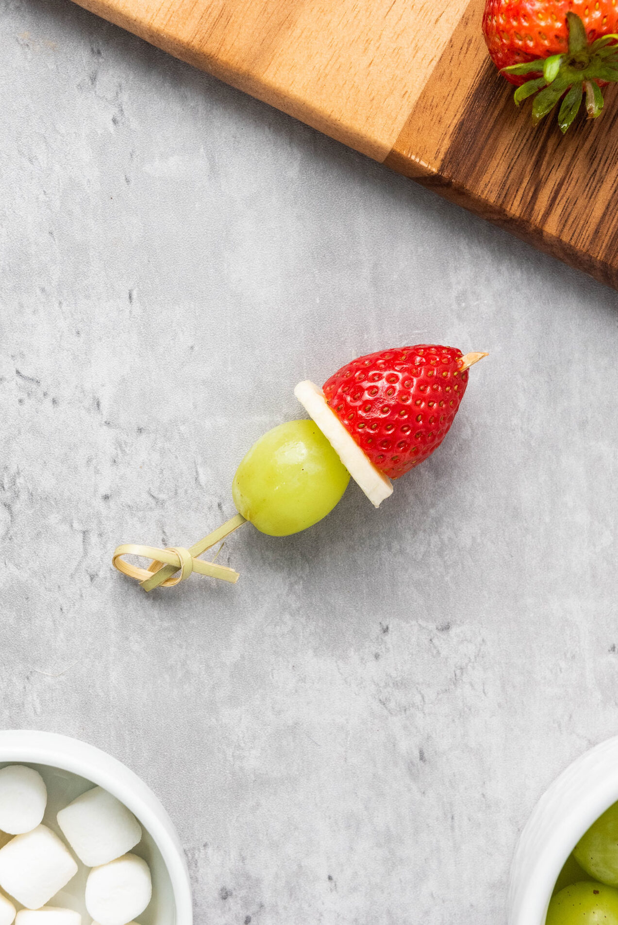 strawberry on top of banana slice on skewer