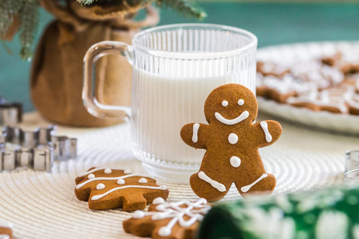 gingerbread man leaning on a cup of milk
