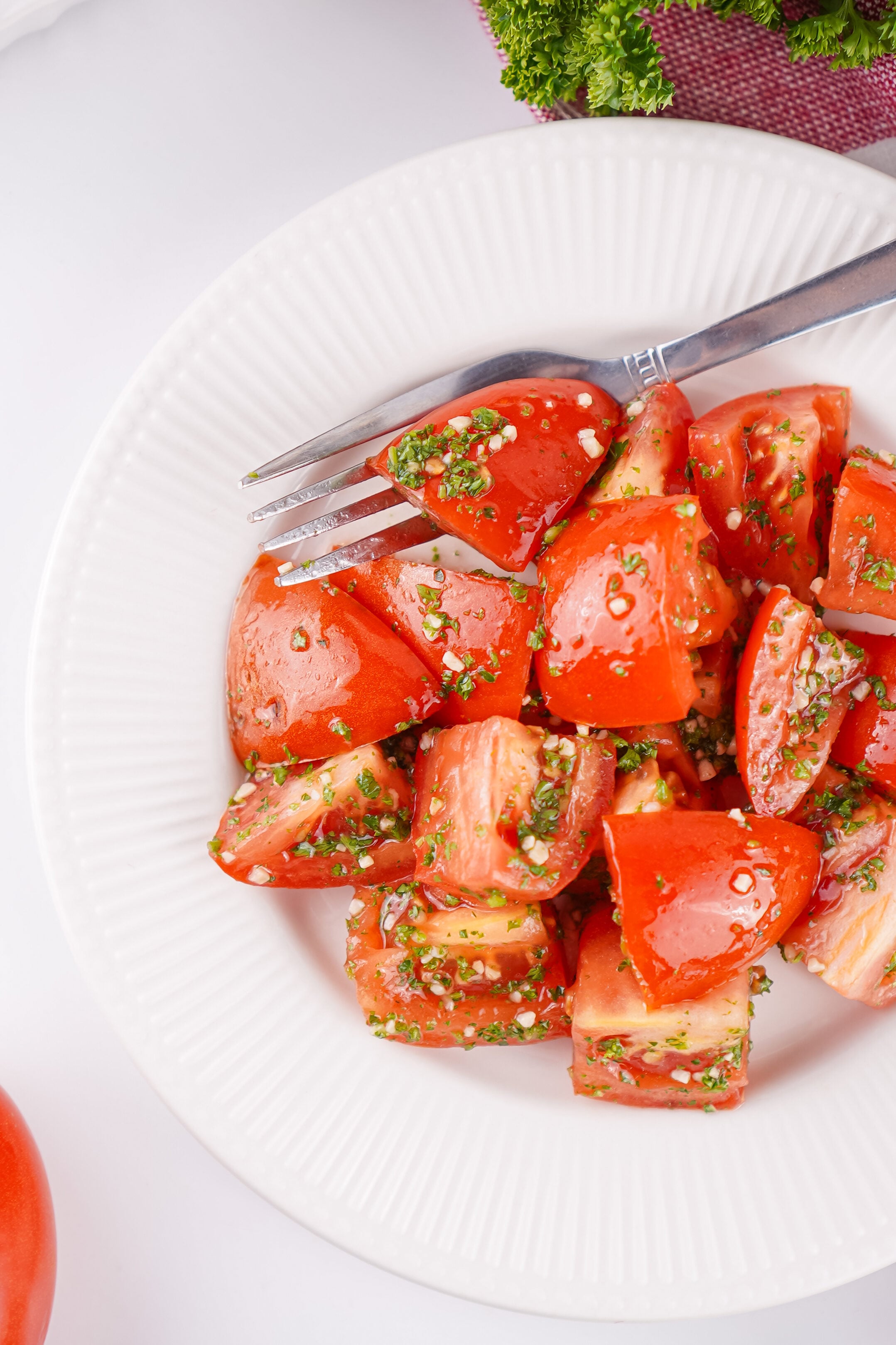 marinated tomatoes in a bowl with a fork