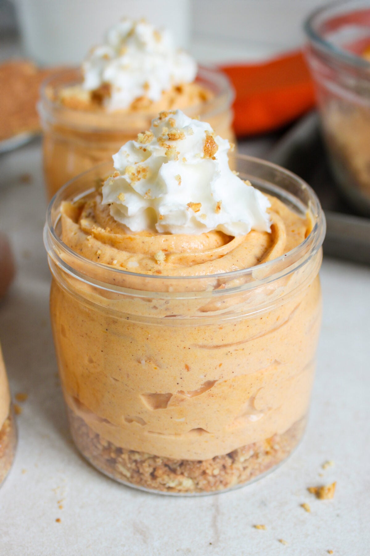 no bake pumpkin cheesecake cups with whipped cream on top