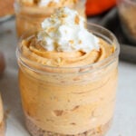 no bake pumpkin cheesecake cups with whipped cream on top