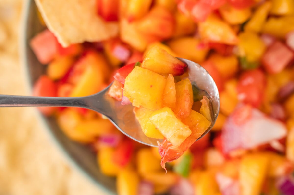 a spoon of peach salsa