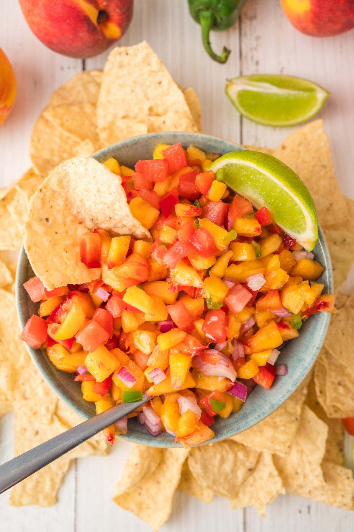 peach salsa with a lime and tortilla chips