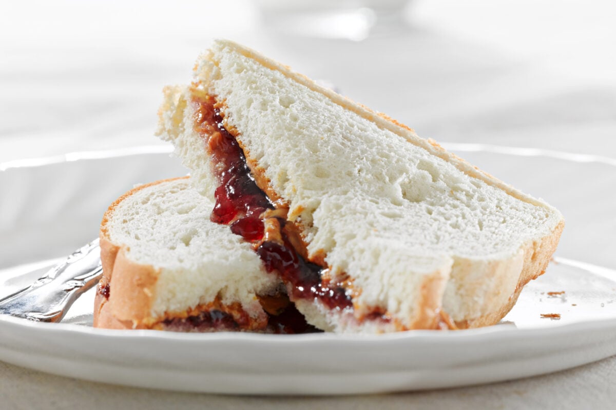 peanut butter and jelly sandwich with grape jelly on a plate