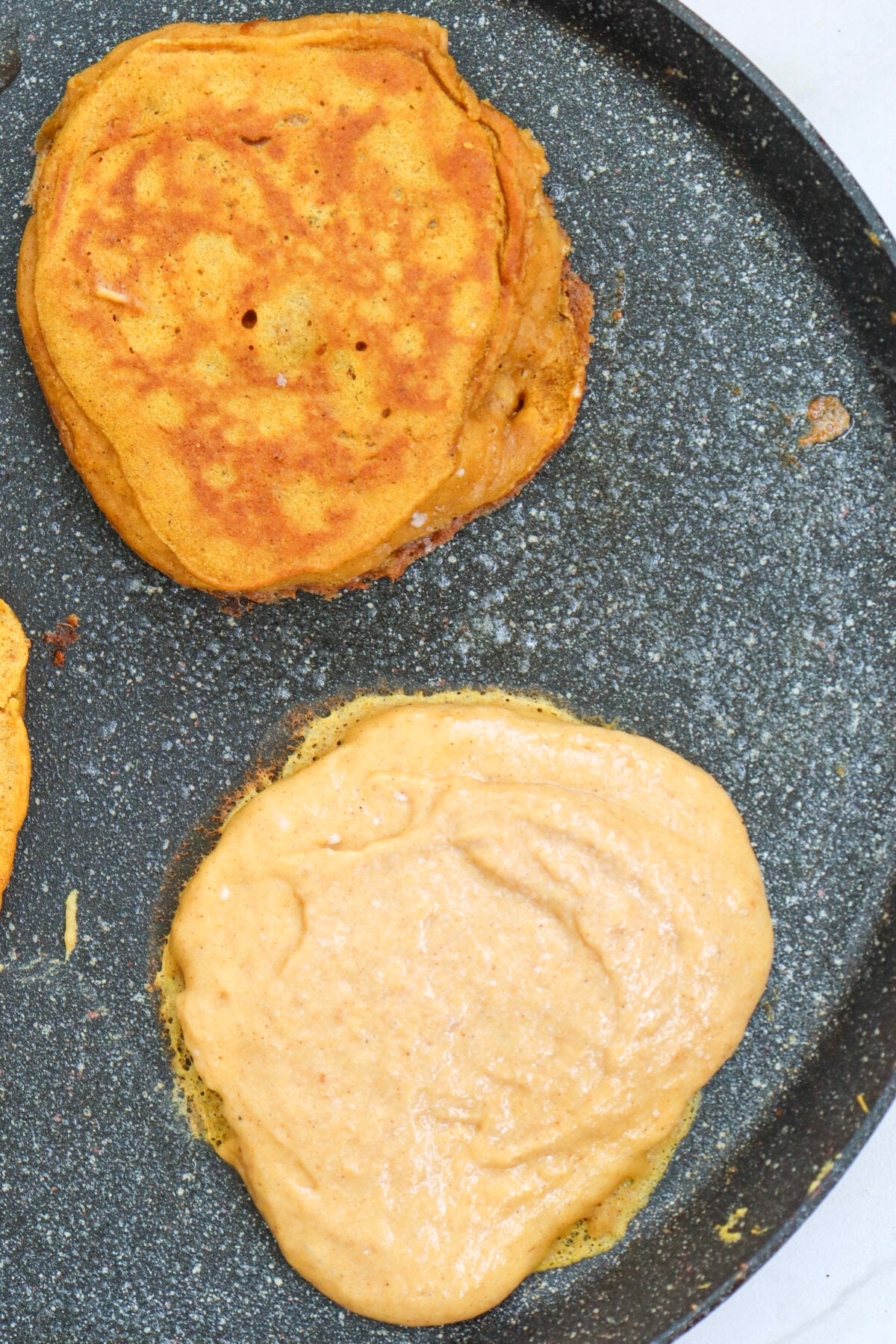 pancakes cooking on griddle
