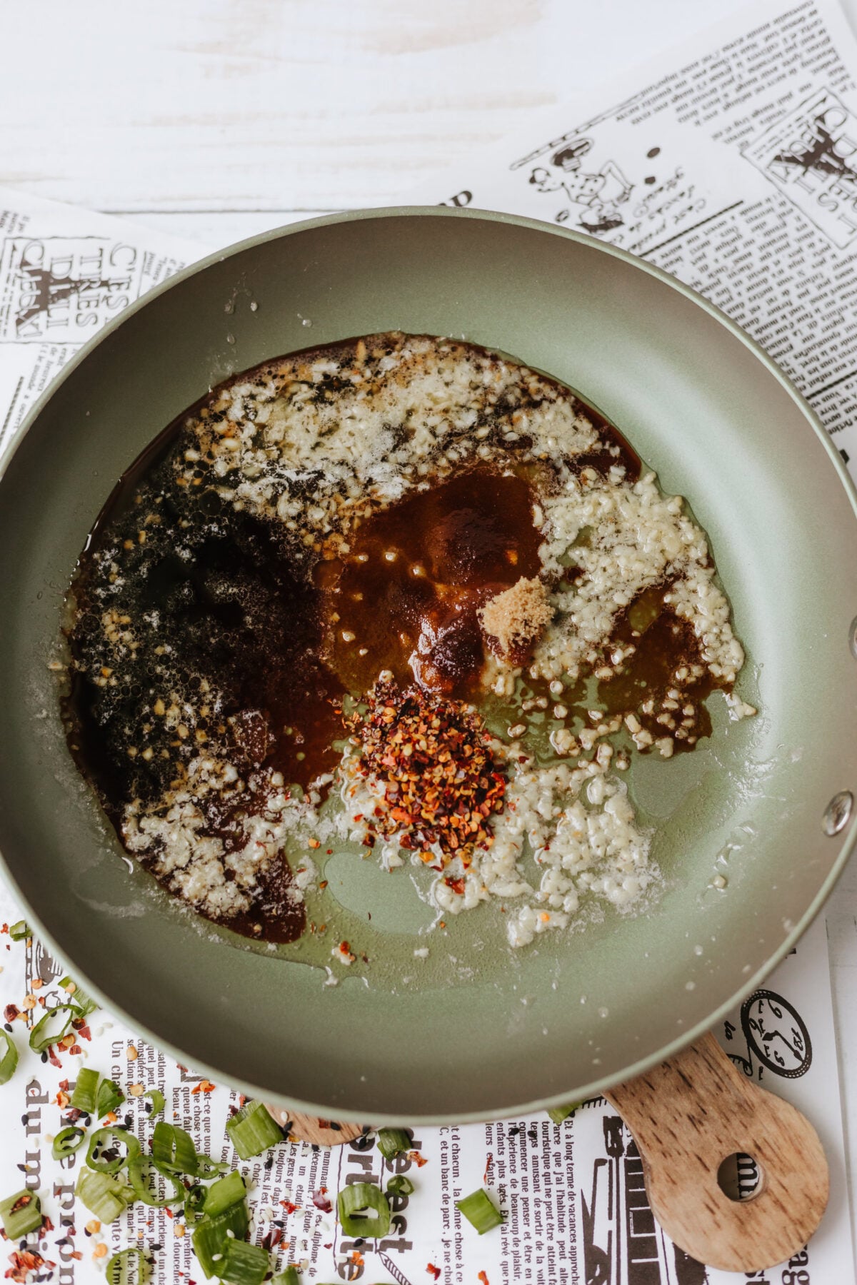 seasonings and soy sauce added to skillet